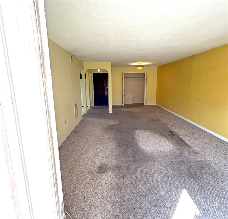 6 Shadowbrook Lane, Unit 9 Milford, MA 01757 - Photo 3 of 14 a view of an empty room with a window