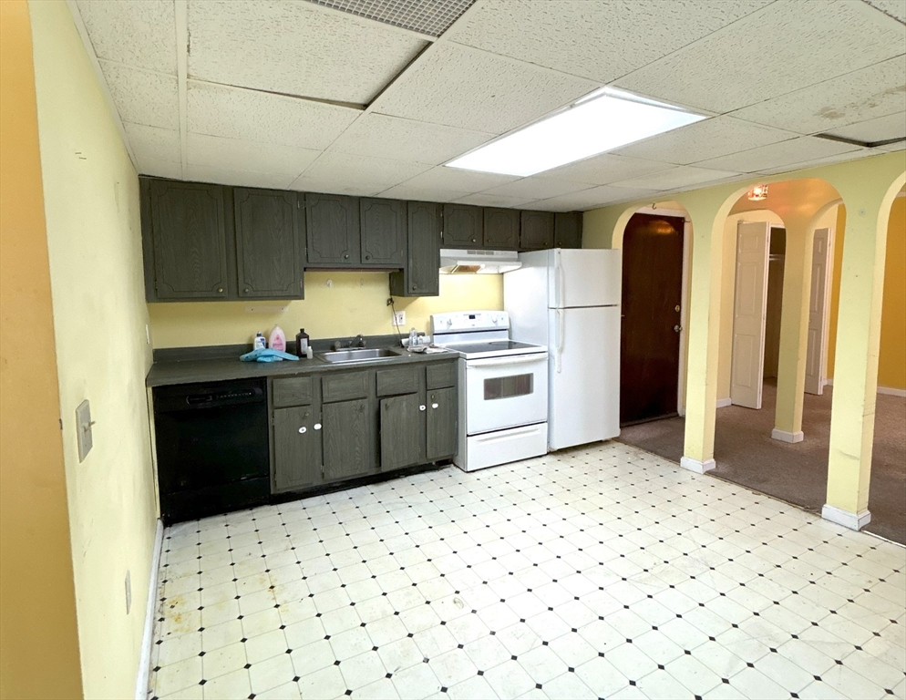 6 Shadowbrook Lane, Unit 9 Milford, MA 01757 - Photo 5 of 14 a kitchen with a sink a refrigerator and cabinets