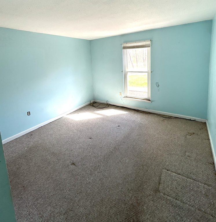 6 Shadowbrook Lane, Unit 9 Milford, MA 01757 - Photo 6 of 14 an empty room with a window