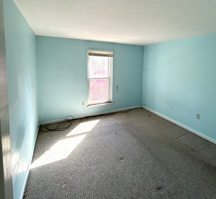 6 Shadowbrook Lane, Unit 9 Milford, MA 01757 - Photo 8 of 14 an empty room with a window