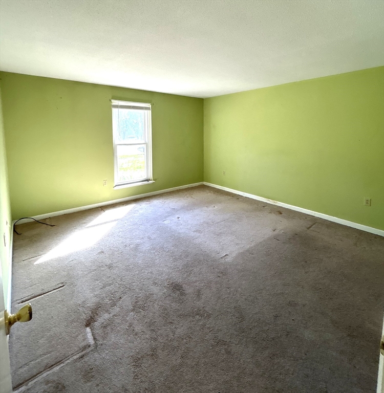 6 Shadowbrook Lane, Unit 9 Milford, MA 01757 - Photo 9 of 14 an empty room with a empty space and a window
