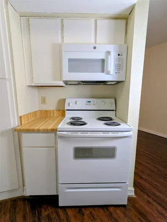 a stove top oven sitting inside of a kitchen