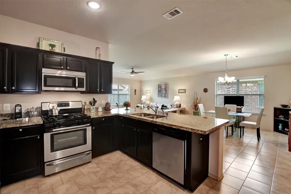 a kitchen with a sink stove and microwave