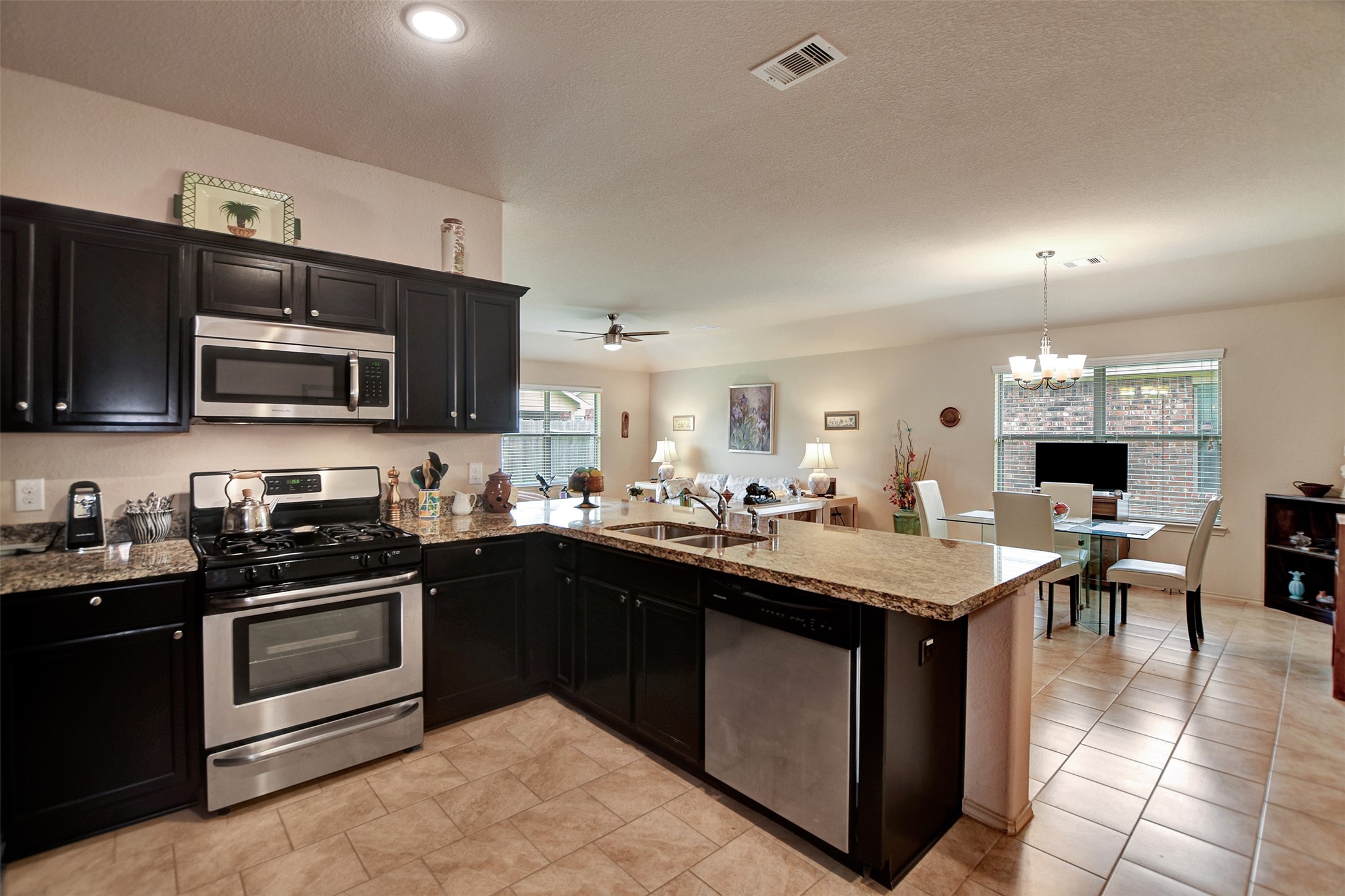 23314 Sawmill Pass Spring, TX 77373 - Photo 14 of 41 a kitchen with a sink stove and microwave