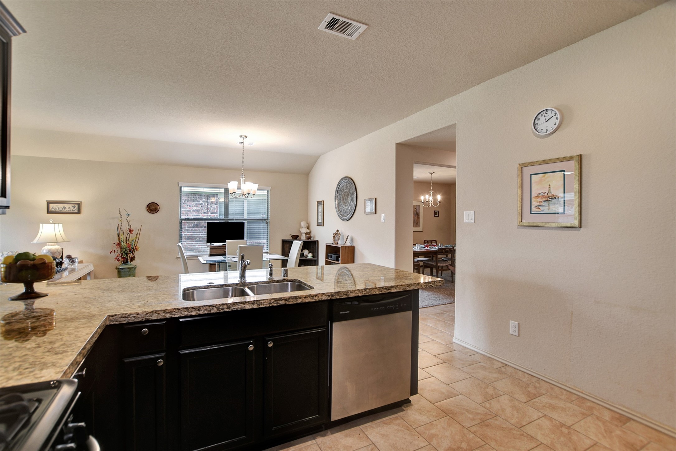 23314 Sawmill Pass Spring, TX 77373 - Photo 16 of 41 a kitchen with a sink a counter top space and living room
