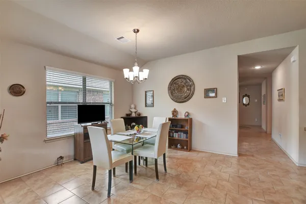 a view of a dining room with furniture and a chandelier