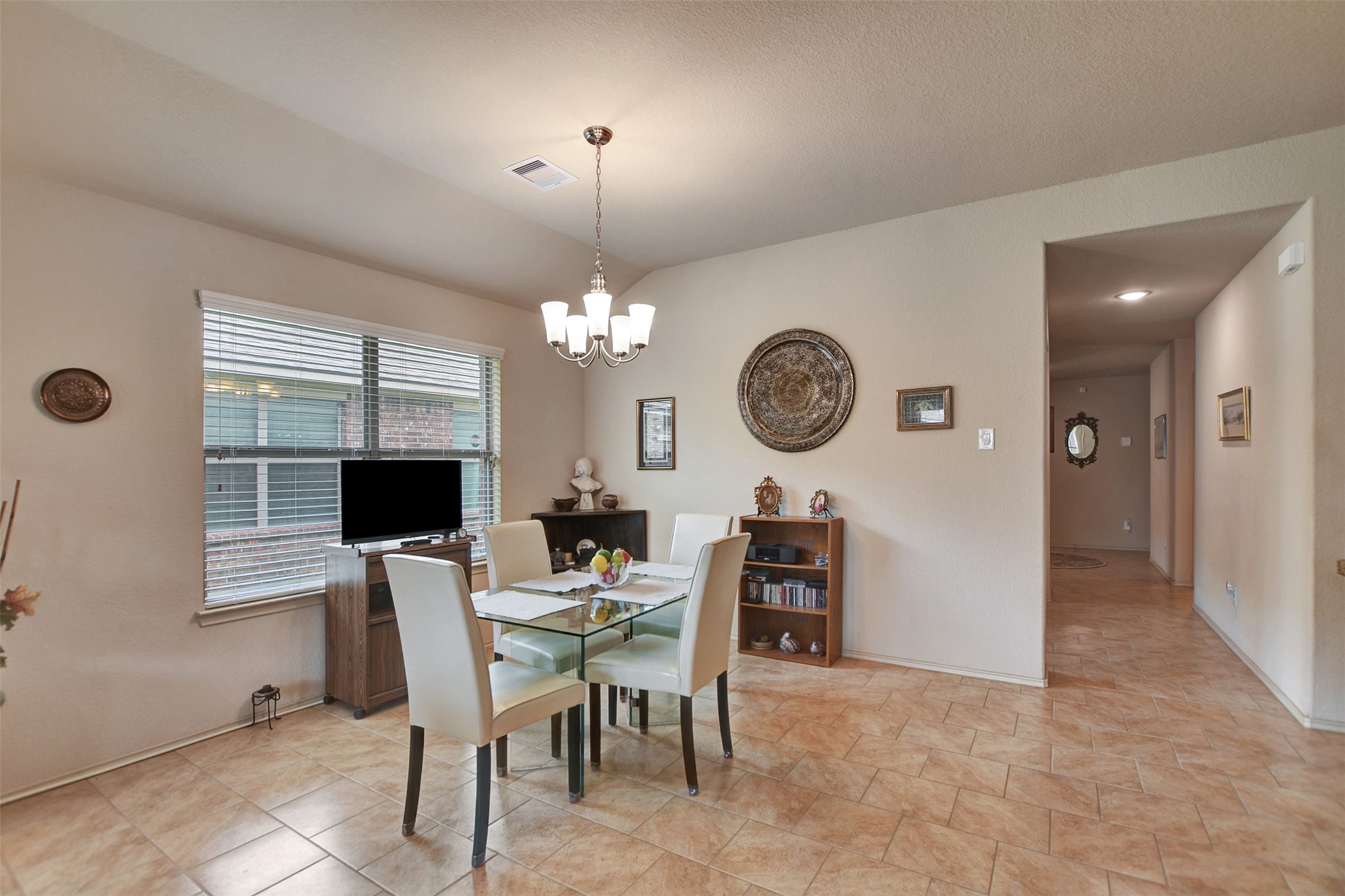23314 Sawmill Pass Spring, TX 77373 - Photo 18 of 41 a view of a dining room with furniture and a chandelier