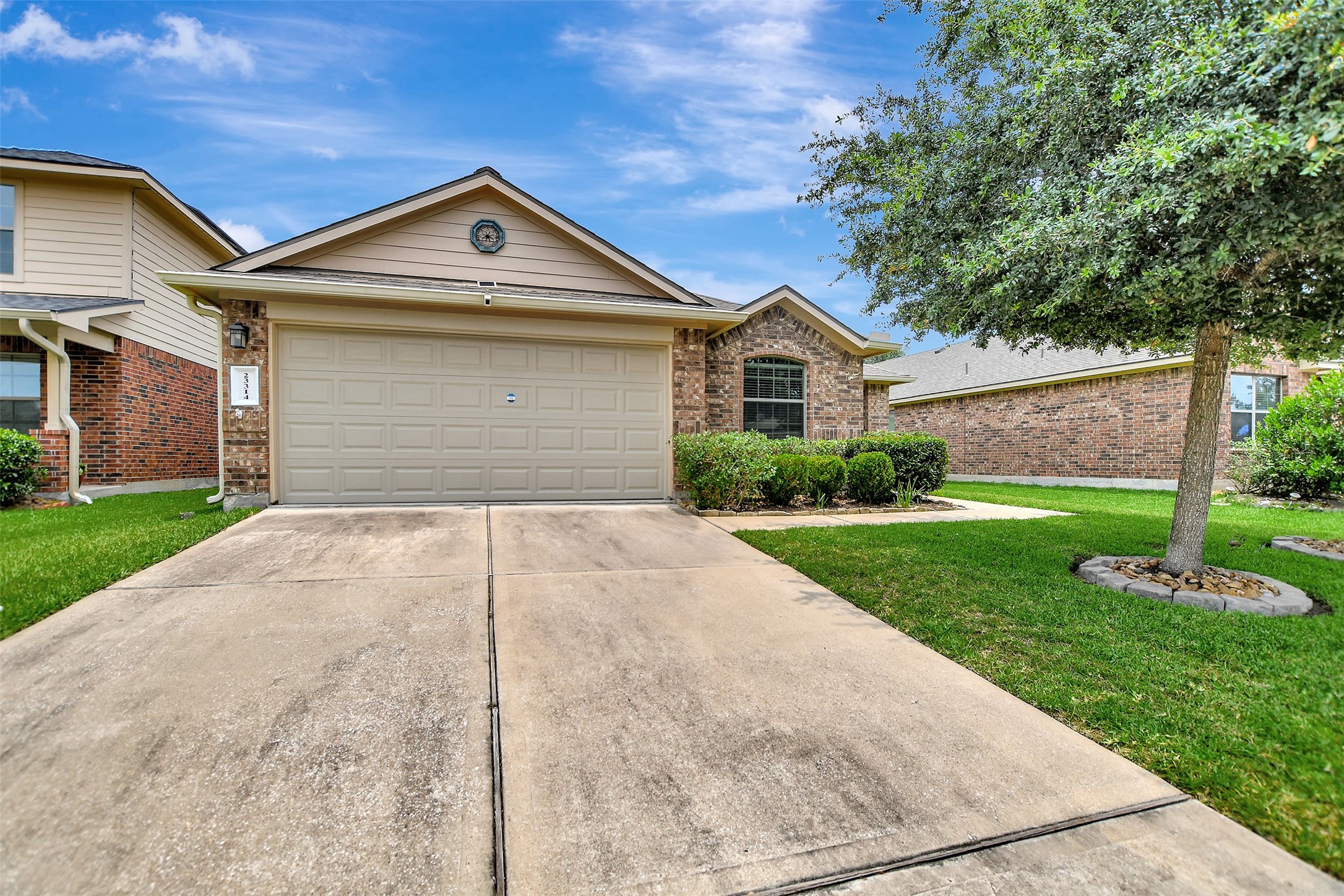 23314 Sawmill Pass Spring, TX 77373 - Photo 2 of 41 a front view of a house with a yard and garage