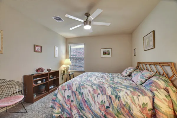 a bedroom with a bed and a dresser