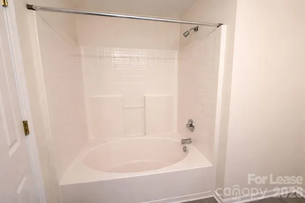 a bathroom with a shower and a bath tub