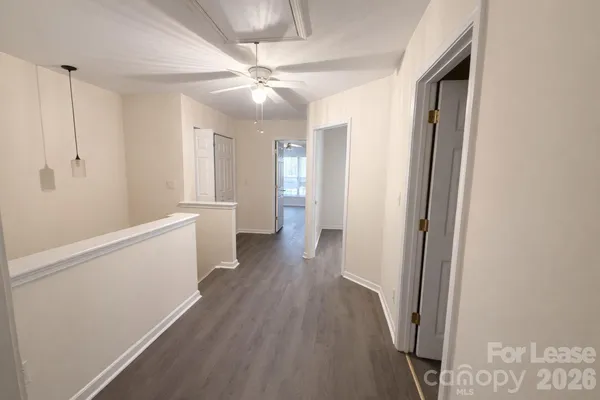 a view of a hallway with wooden floor