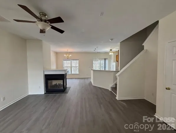 a view of main area wooden floor and a fireplace