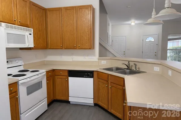 a kitchen with a sink stove and cabinets