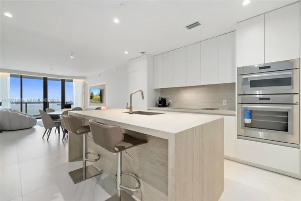 a kitchen with a table chairs stove and cabinets