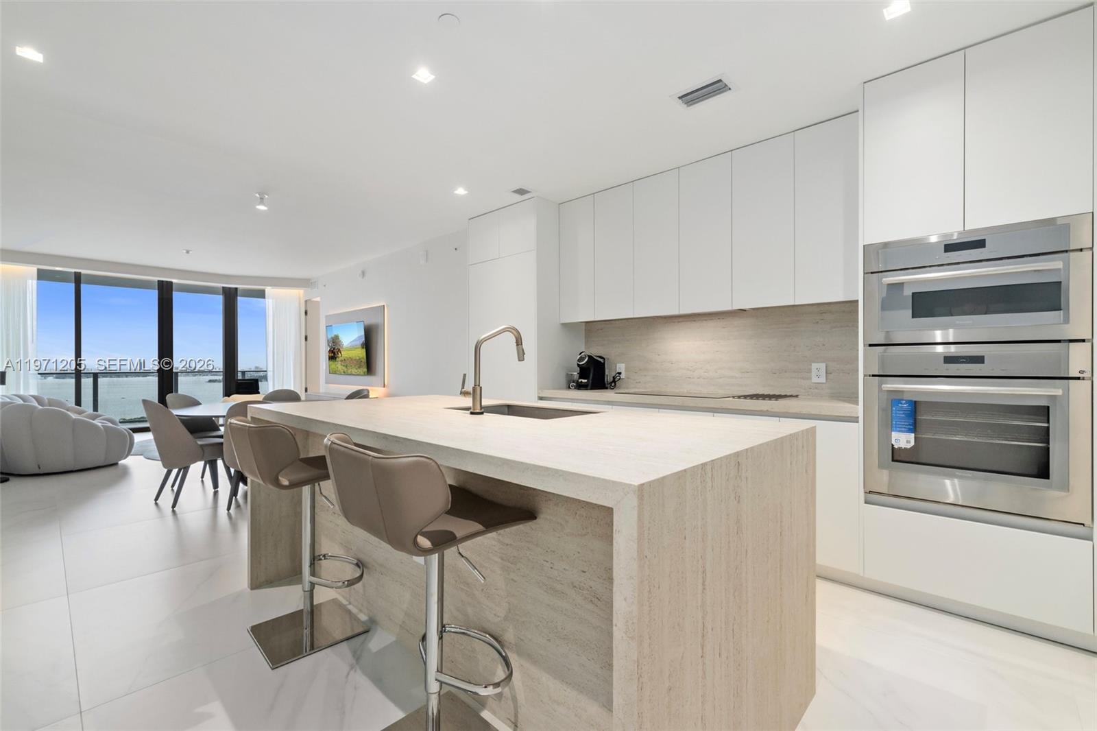 a kitchen with a table chairs stove and cabinets
