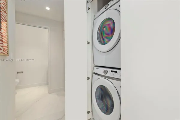 a bathroom with a washing machine and a washer dryer