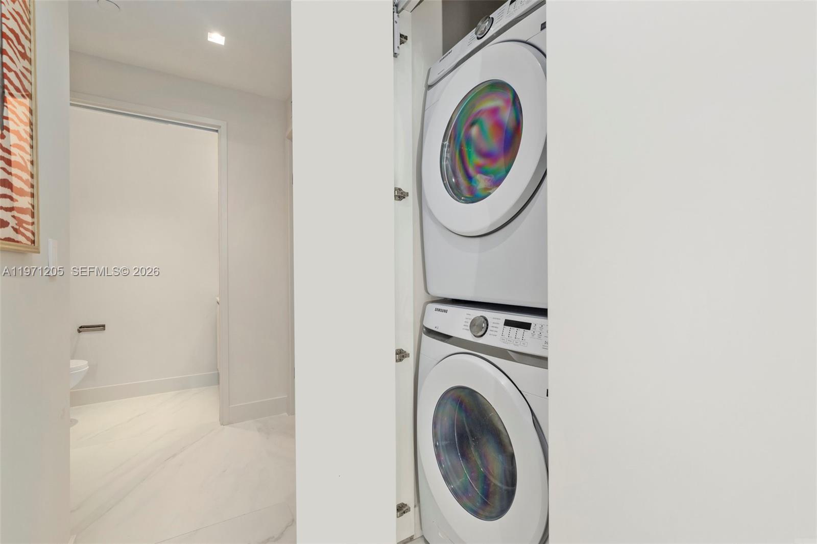 700 Northeast 24th Street, Unit 2505 Miami, FL 33137 - Photo 12 of 19 a bathroom with a washing machine and a washer dryer
