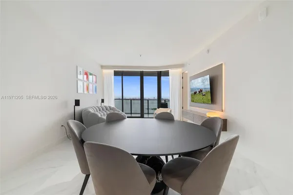 a view of a dining room with furniture and window