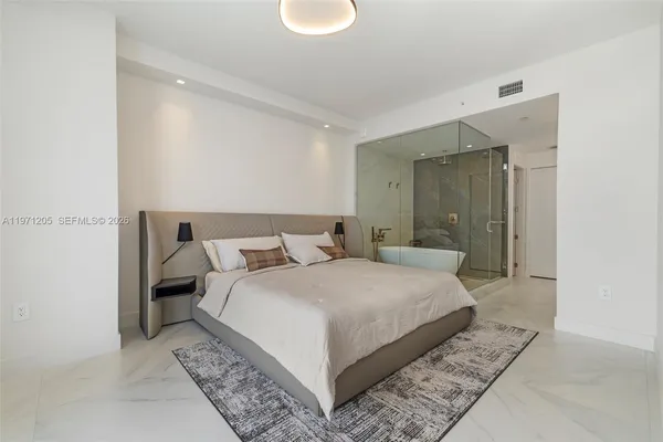 a bedroom with a bed and a mirror