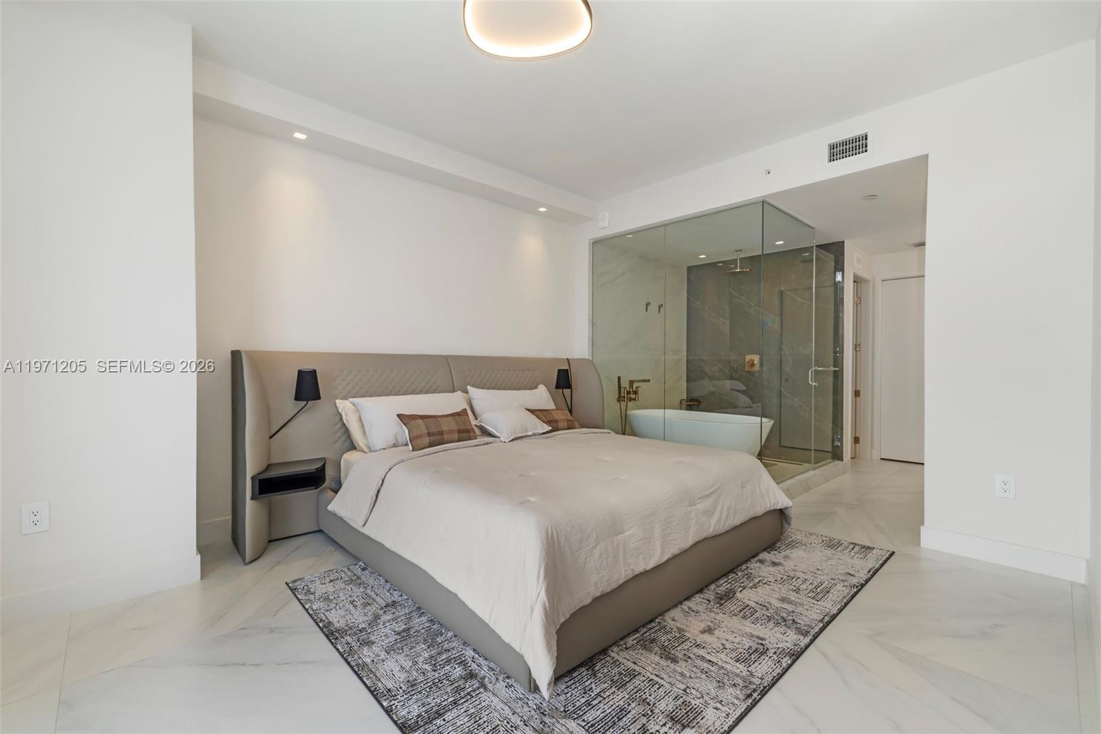 700 Northeast 24th Street, Unit 2505 Miami, FL 33137 - Photo 3 of 19 a bedroom with a bed and a mirror