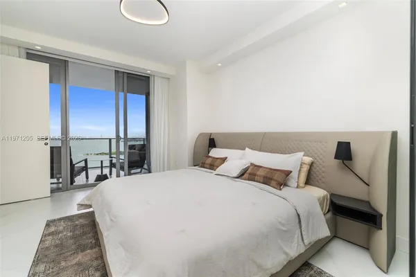 a bedroom with a bed and a table