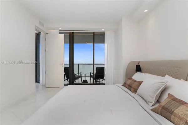 a bed room with a bed and a chair