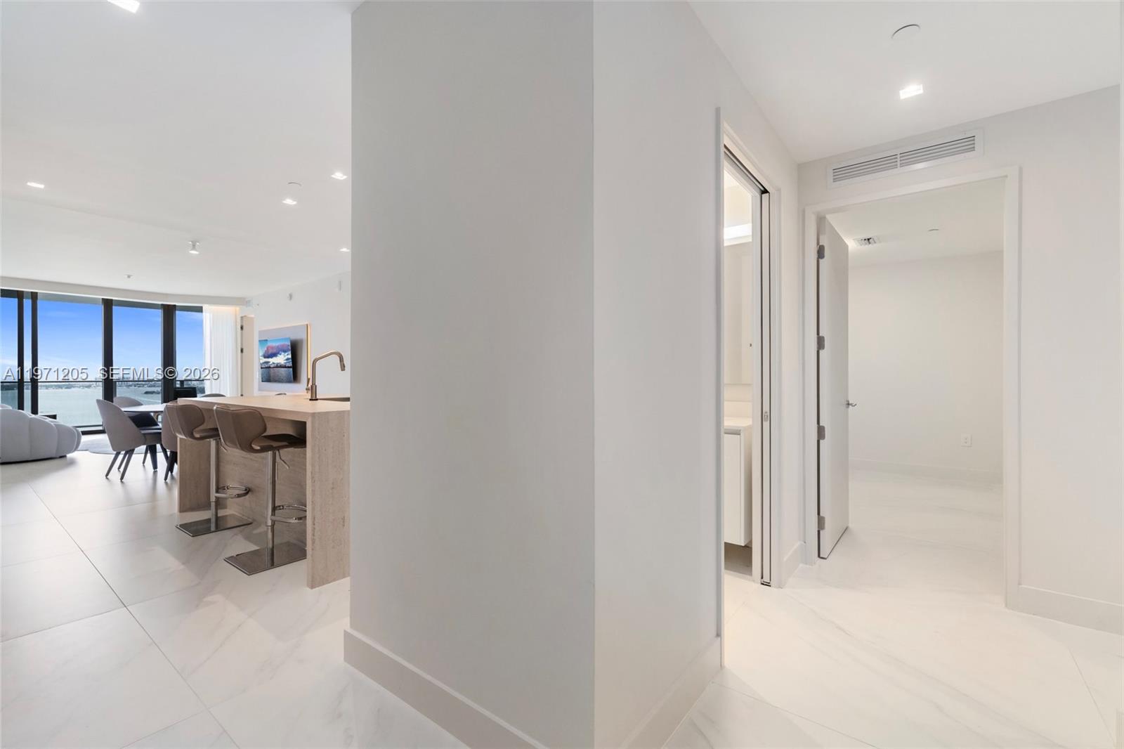 700 Northeast 24th Street, Unit 2505 Miami, FL 33137 - Photo 7 of 19 a view of a hallway with dining area and chandelier