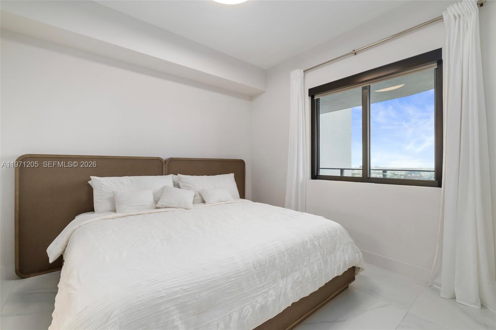 700 Northeast 24th Street, Unit 2505 Miami, FL 33137 - Photo 9 of 19 a bedroom with a bed and a window