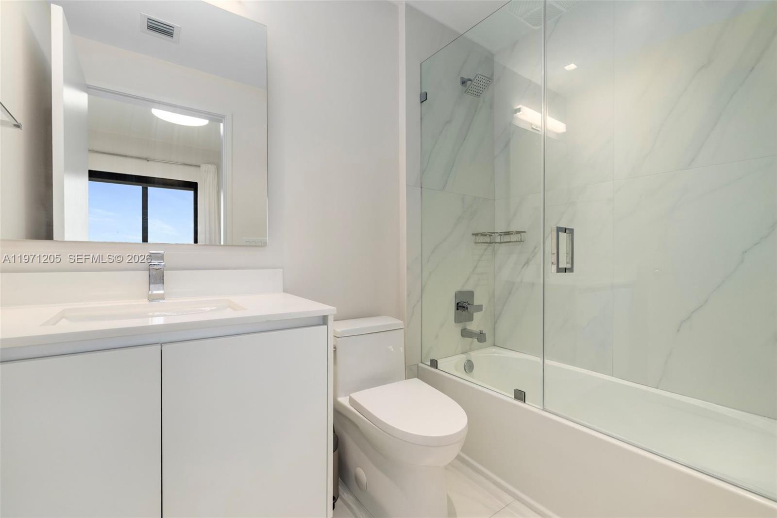 700 Northeast 24th Street, Unit 2505 Miami, FL 33137 - Photo 10 of 19 a bathroom with a sink a toilet and shower