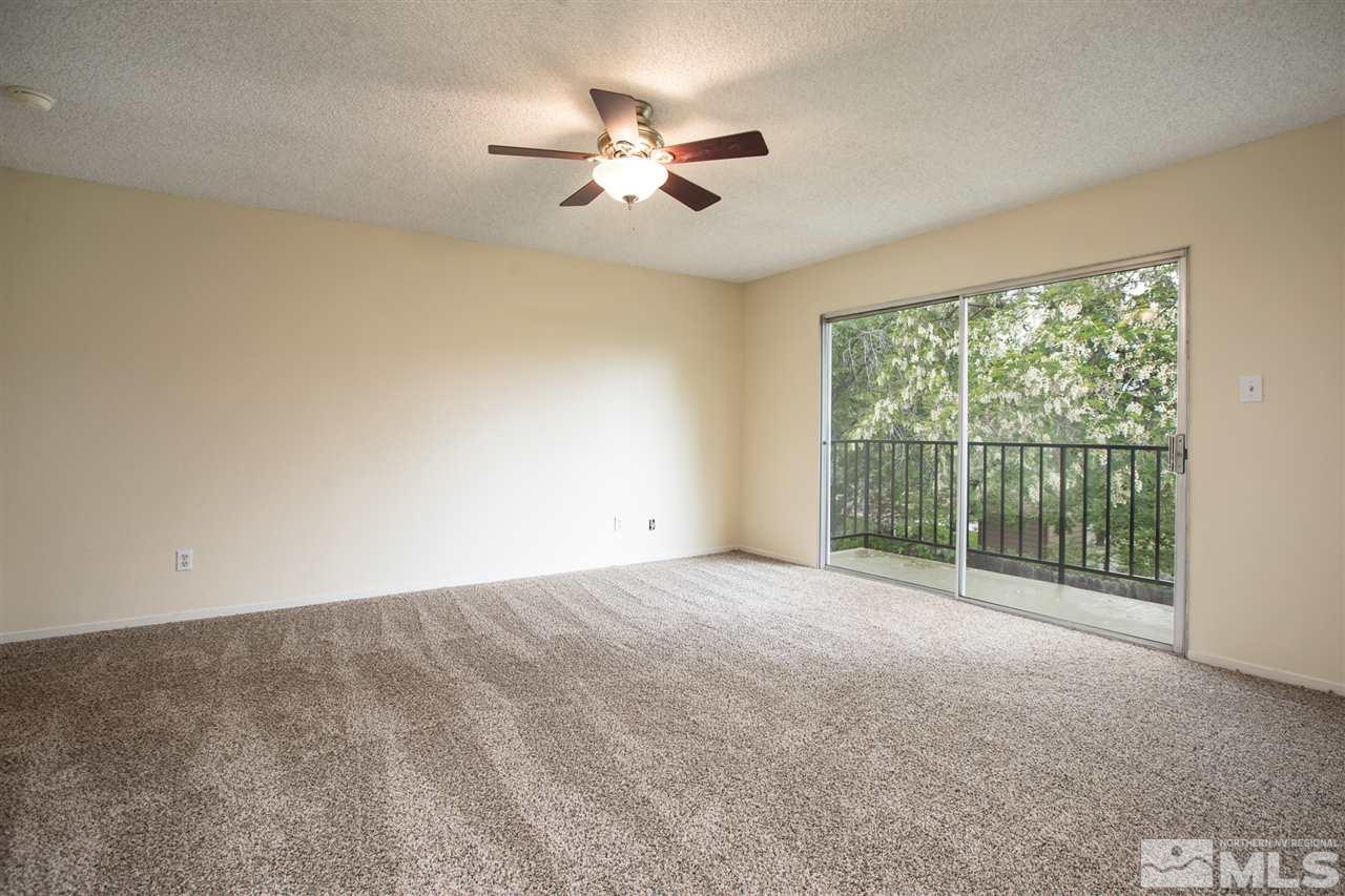 885 Twin Pines Road Reno, NV 89509 - Photo 14 of 25 a view of a livingroom with a ceiling fan and a large window