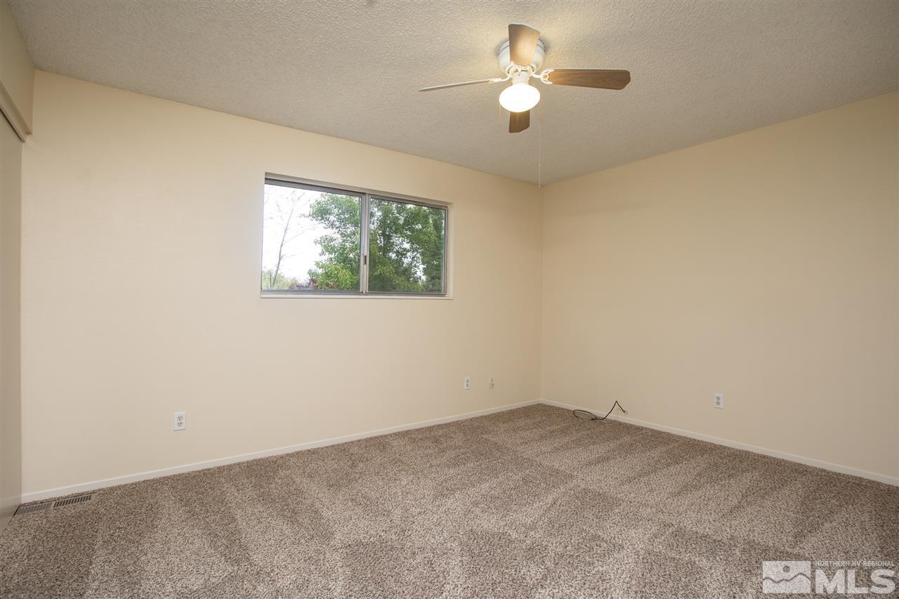 885 Twin Pines Road Reno, NV 89509 - Photo 18 of 25 an empty room with a window and a ceiling fan