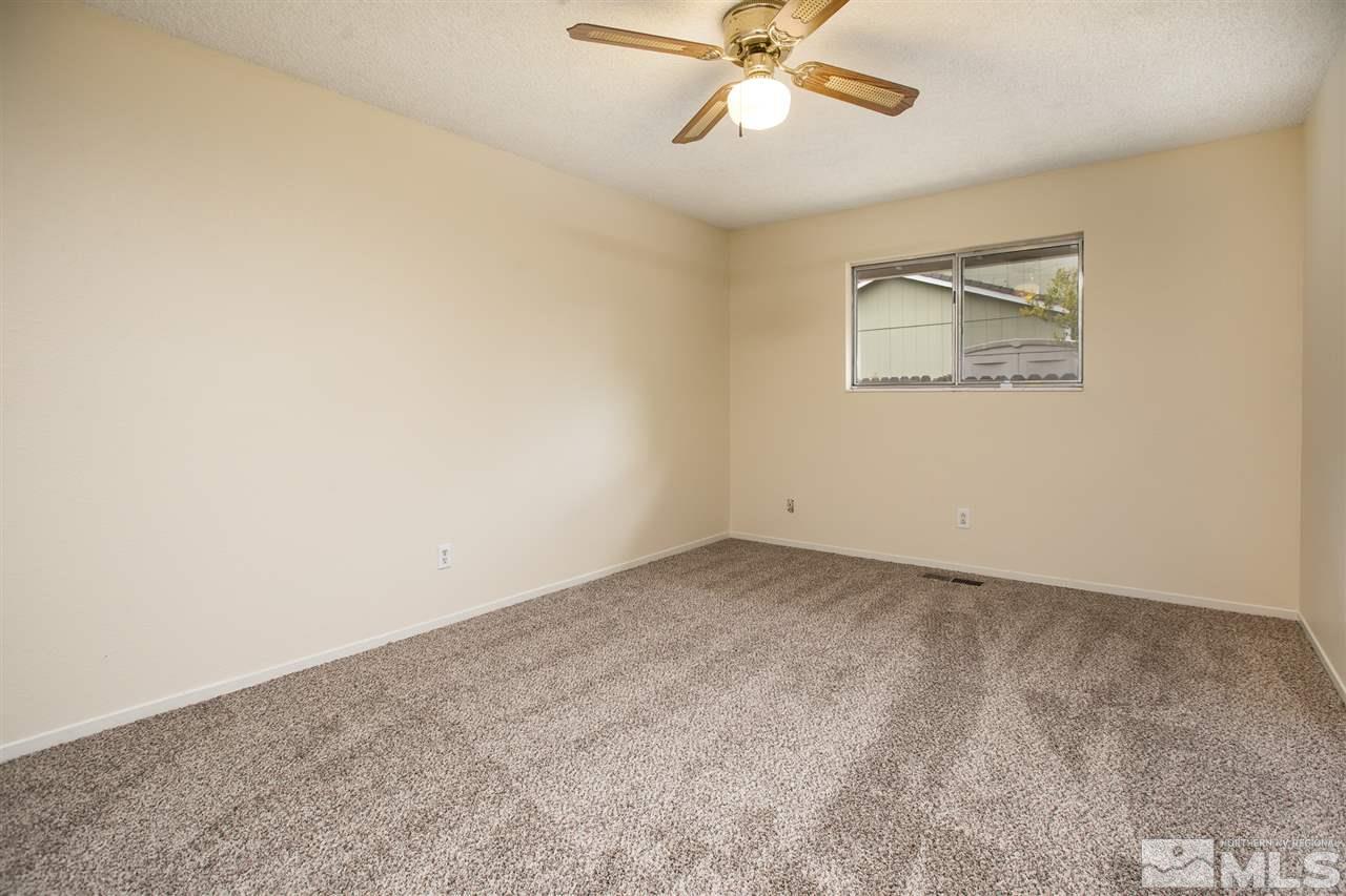 885 Twin Pines Road Reno, NV 89509 - Photo 20 of 25 an empty room with a window and a fan