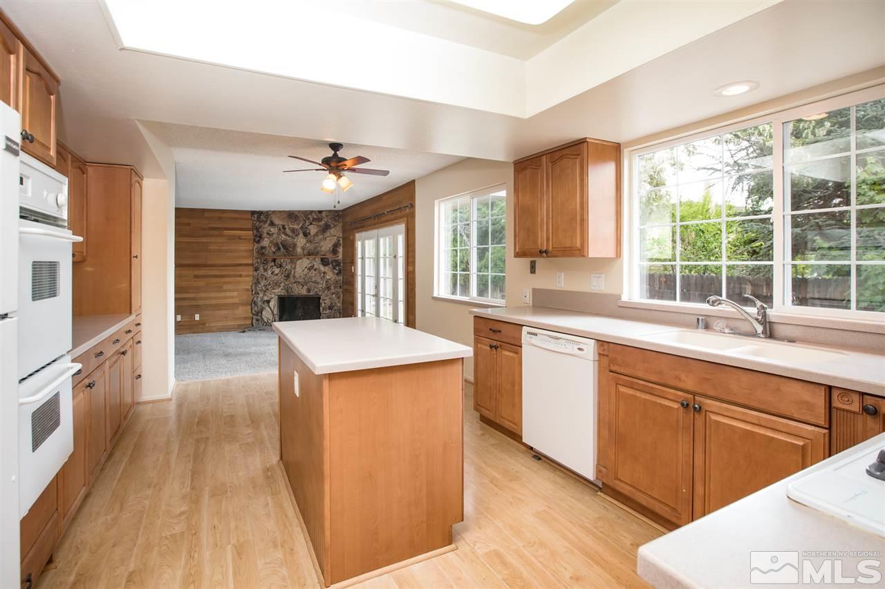885 Twin Pines Road Reno, NV 89509 - Photo 5 of 25 a kitchen with stainless steel appliances granite countertop a stove a sink dishwasher and a refrigerator with wooden floor