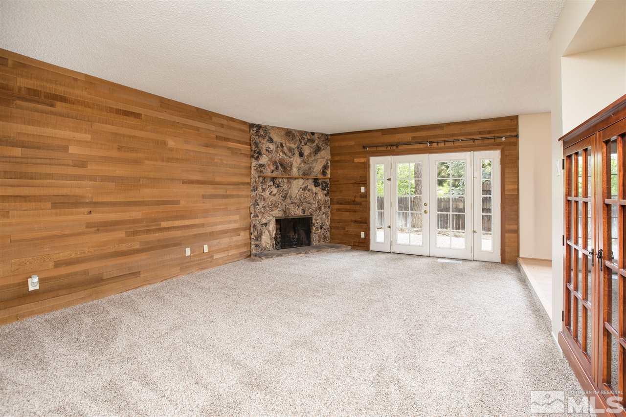 885 Twin Pines Road Reno, NV 89509 - Photo 10 of 25 a view of an empty room with a fireplace and a window