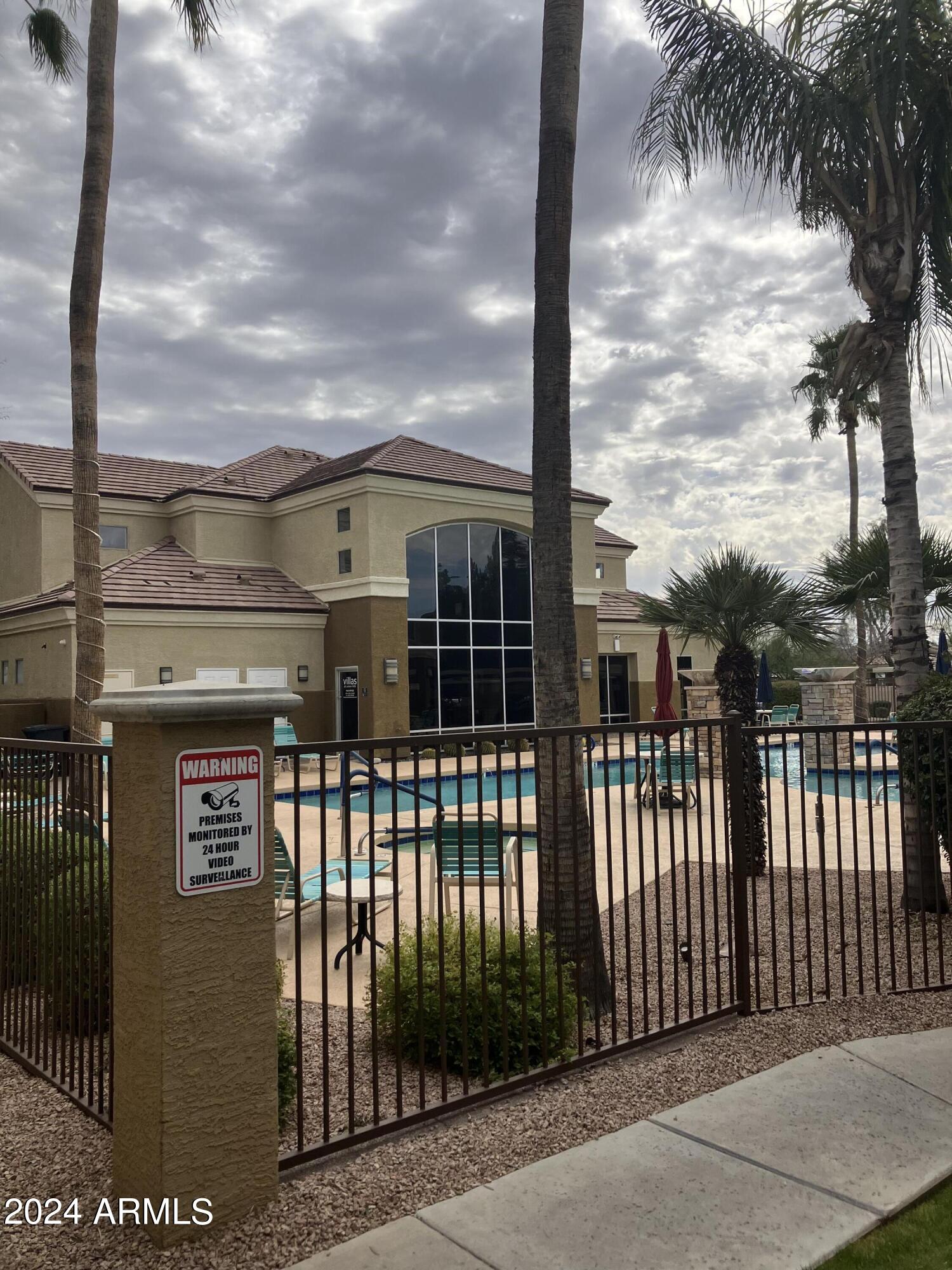 18416 North Cave Creek Road, Unit 2033 Phoenix, AZ 85032 - Photo 16 of 18 a view of a large building with a small yard