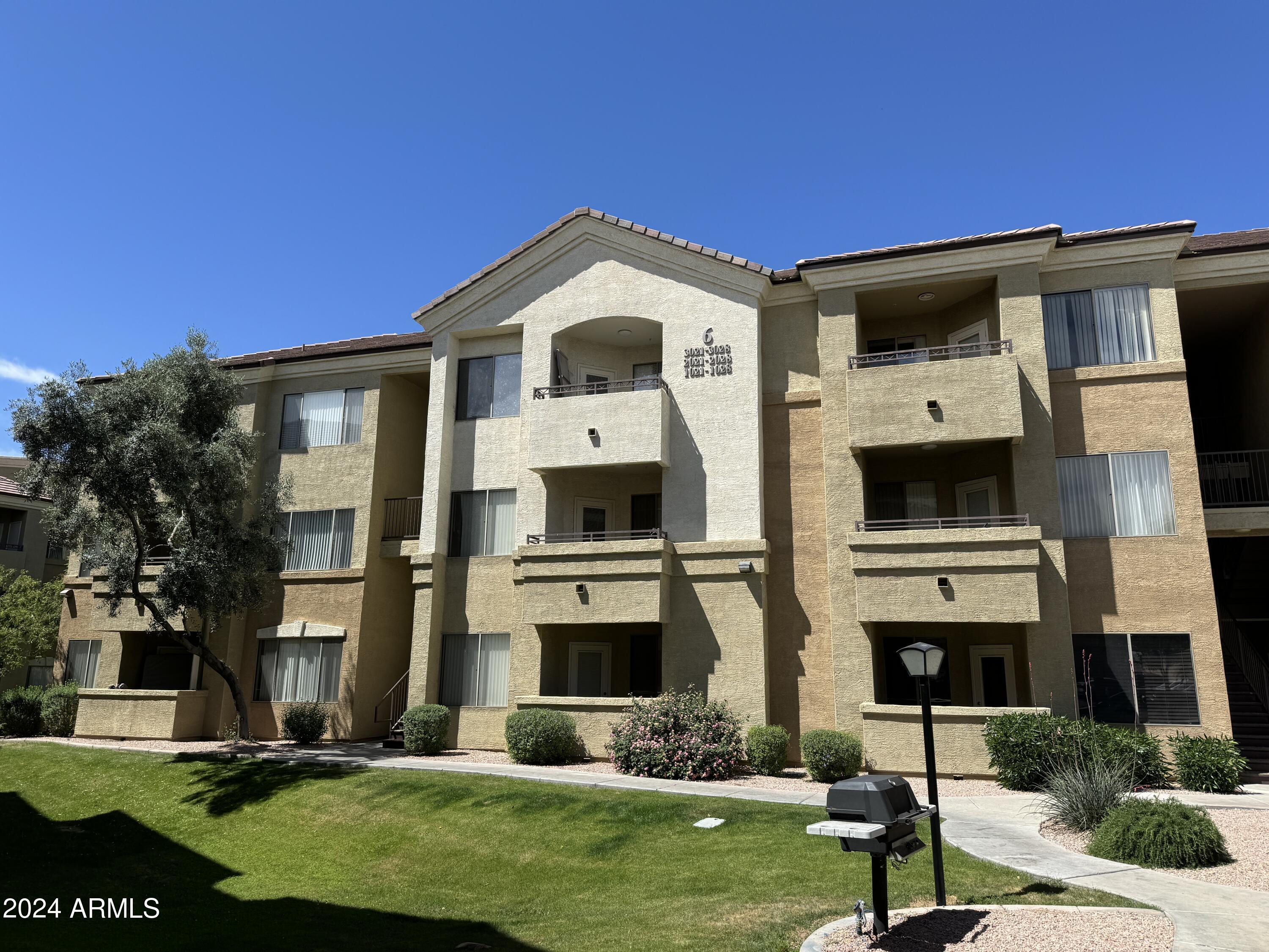 18416 North Cave Creek Road, Unit 2033 Phoenix, AZ 85032 - Photo 18 of 18 a front view of a house with a yard