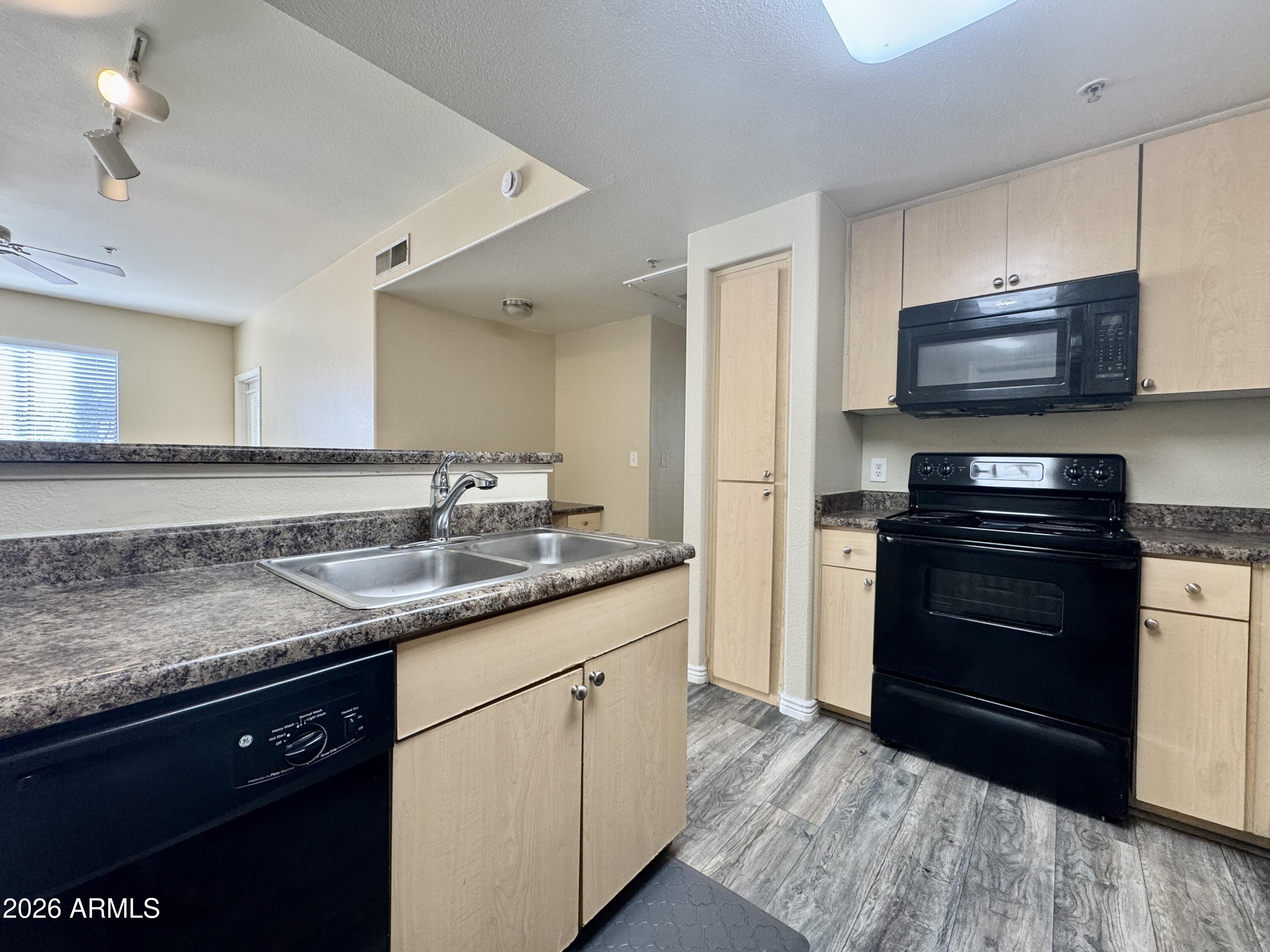 18416 North Cave Creek Road, Unit 2033 Phoenix, AZ 85032 - Photo 2 of 18 a kitchen with granite countertop a sink and steel appliances