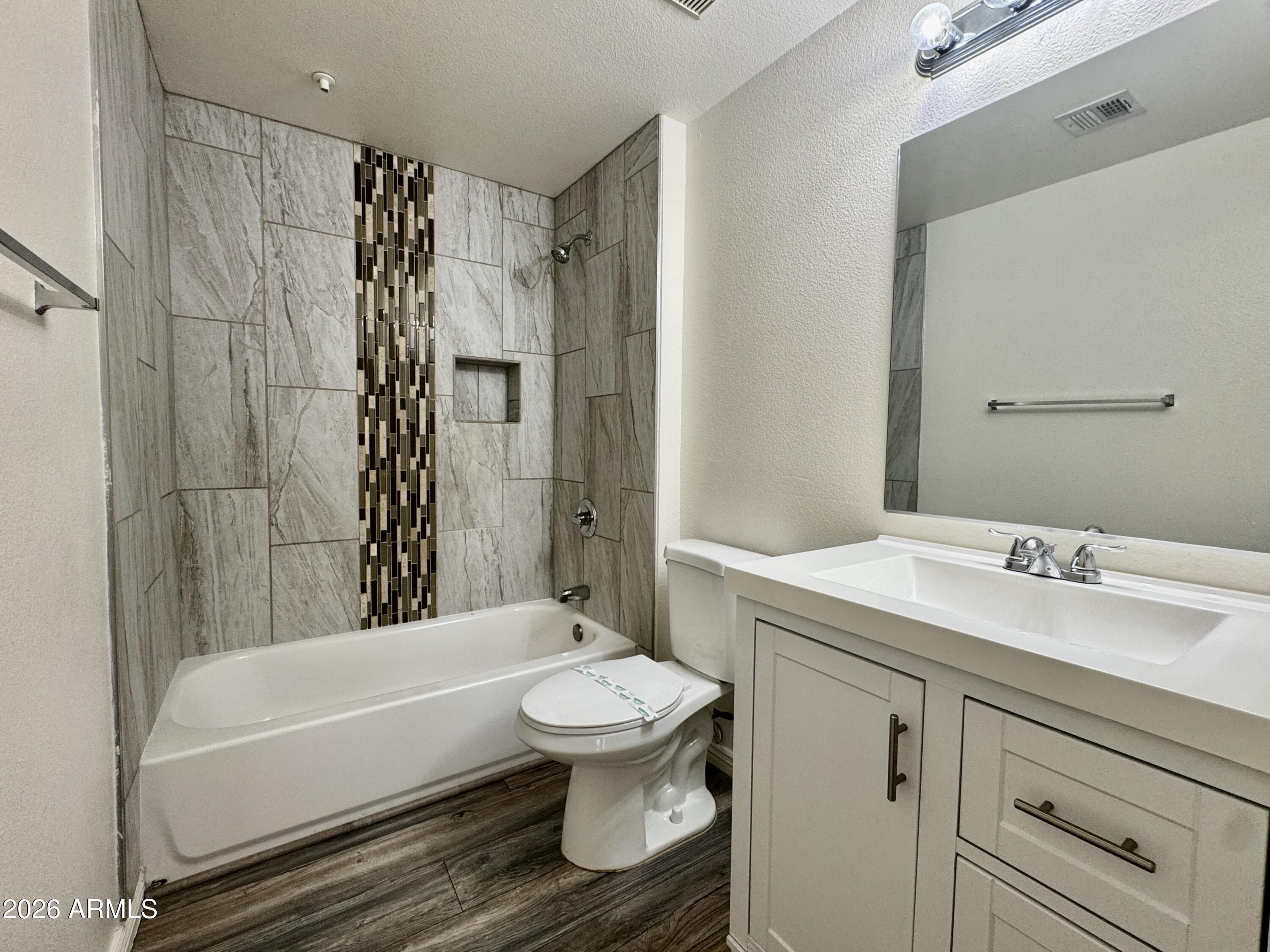 18416 North Cave Creek Road, Unit 2033 Phoenix, AZ 85032 - Photo 7 of 18 a bathroom with a sink toilet and shower