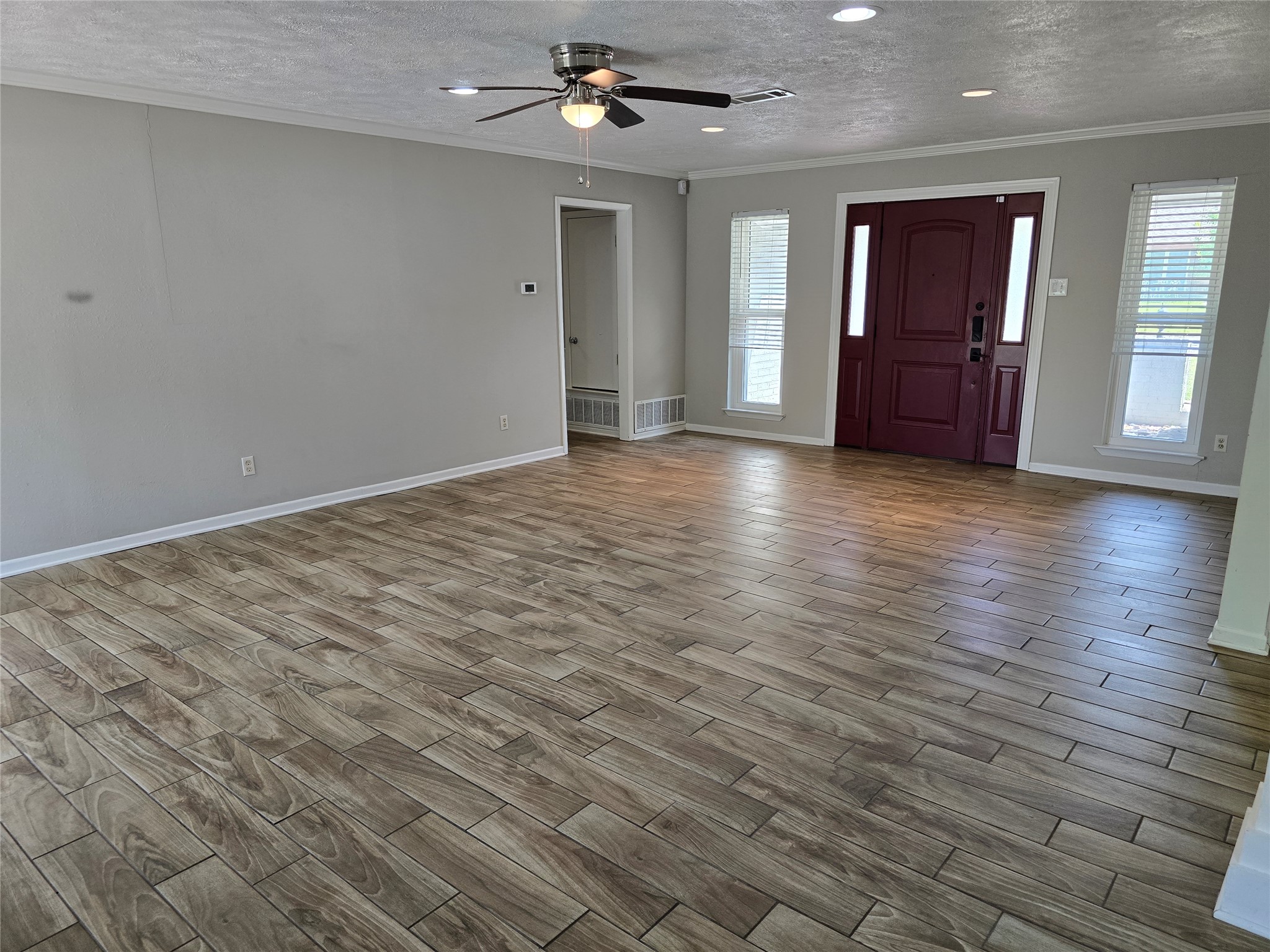 205 East Cherokee Drive Harker Heights, TX 76548 - Photo 6 of 23 A spacious entry with wood-look tile flooring leads to a rich, dark-stained front door flanked by bright sidelight windows.
