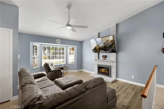 a bedroom with furniture fireplace and flat screen tv