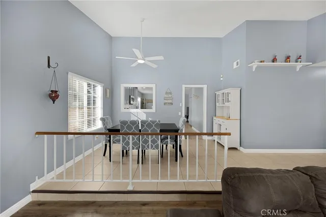 a view of dining room and livingroom with furniture wooden floor a rug and a chandelier
