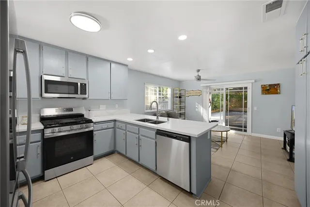 a kitchen with a sink stove and microwave