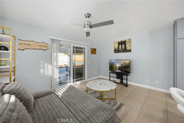 a living room with furniture a rug and a window