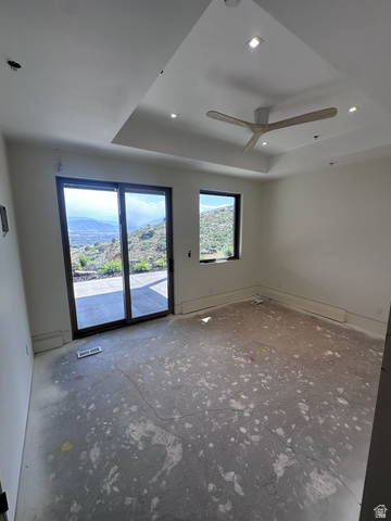 1918 Chimney Rock Road Heber City, UT 84032 - Photo 63 of 74 Room featuring a tray ceiling with recessed lighting and a ceiling fan, a sliding glass door, and an additional window