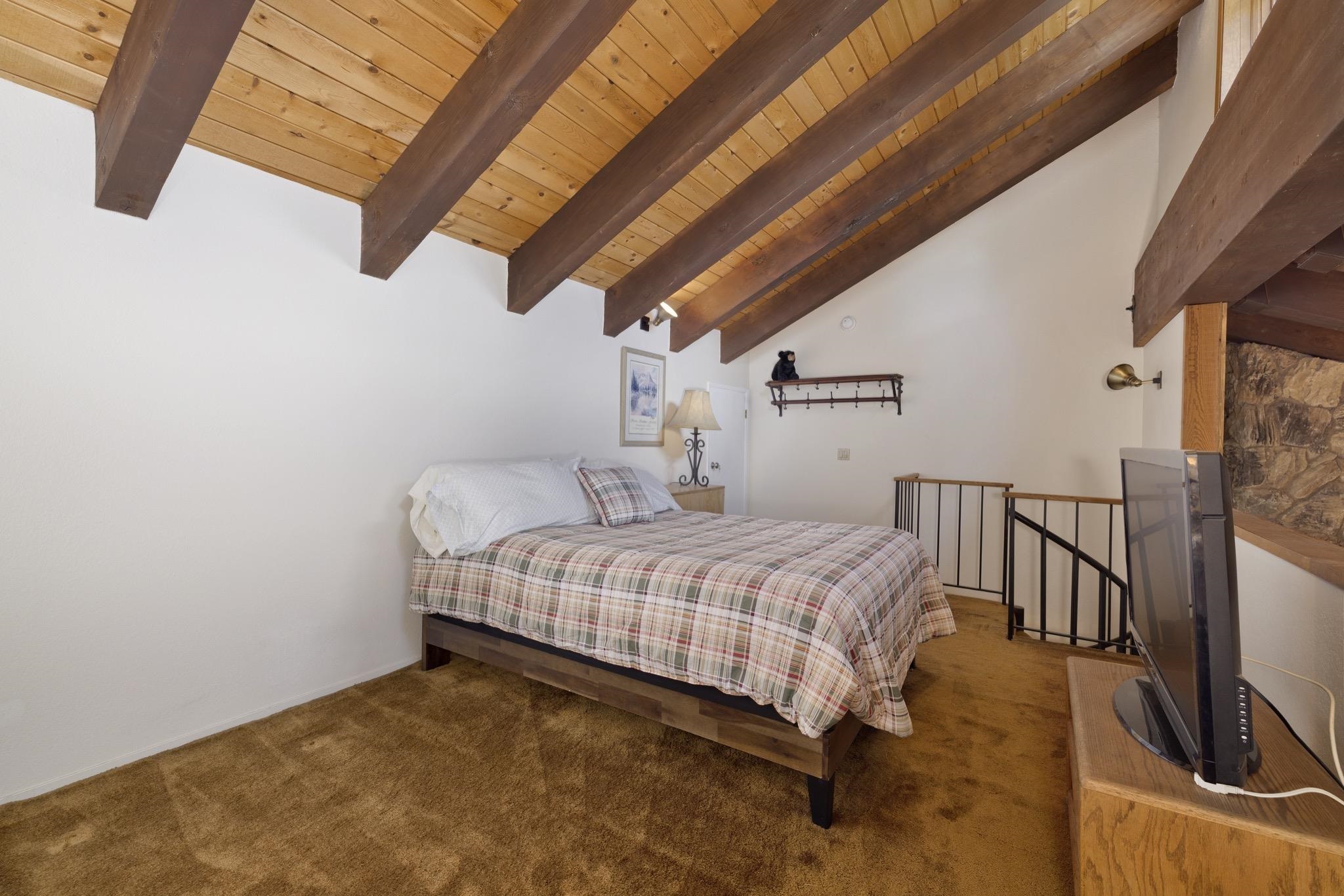 484 Manzanita Road, Unit 16 Mammoth Lakes, CA 93546 - Photo 23 of 34 a bedroom with a bed and wooden floor