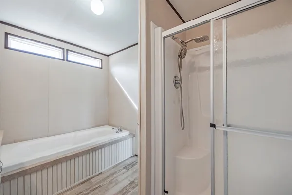 a bathroom with a glass shower door