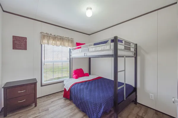 a bed room with a bed and a window