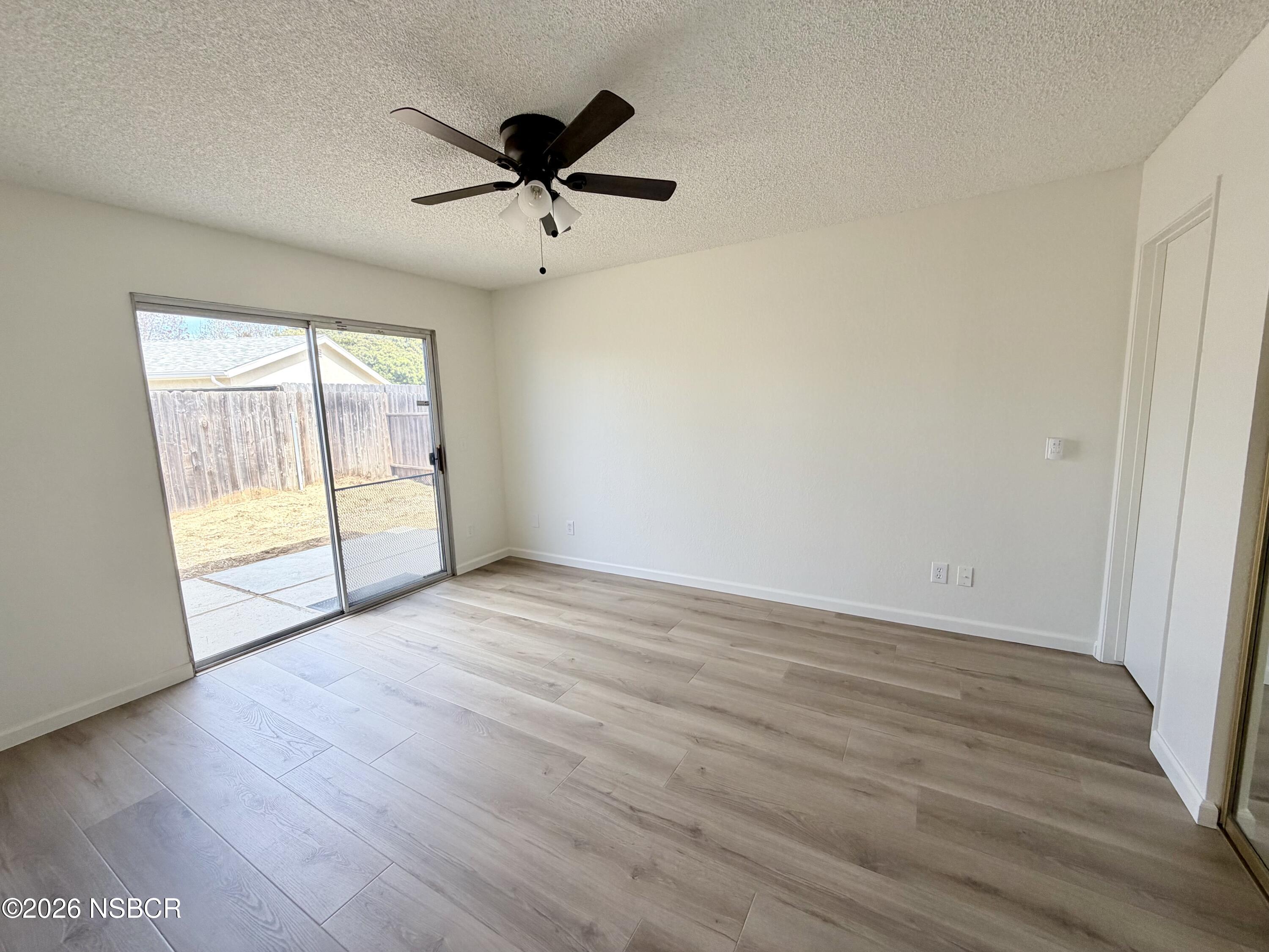 181 Janet Avenue Grover Beach, CA 93433 - Photo 14 of 21 a view of empty room with wooden floor and fan