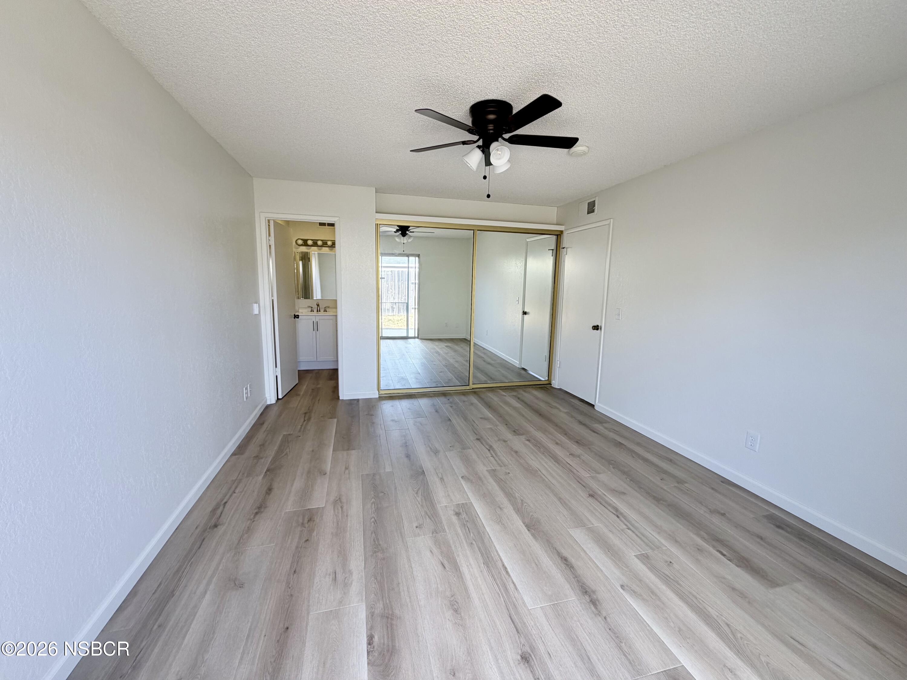 181 Janet Avenue Grover Beach, CA 93433 - Photo 15 of 21 a view of empty room with wooden floor and ceiling fan