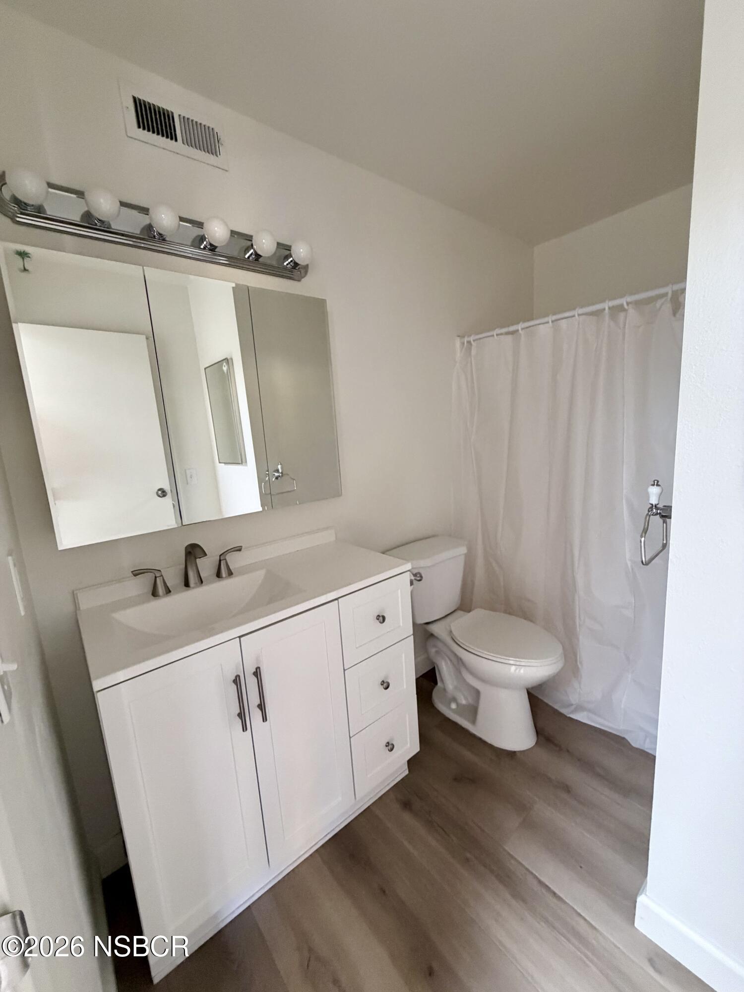 181 Janet Avenue Grover Beach, CA 93433 - Photo 16 of 21 a bathroom with a toilet sink and mirror